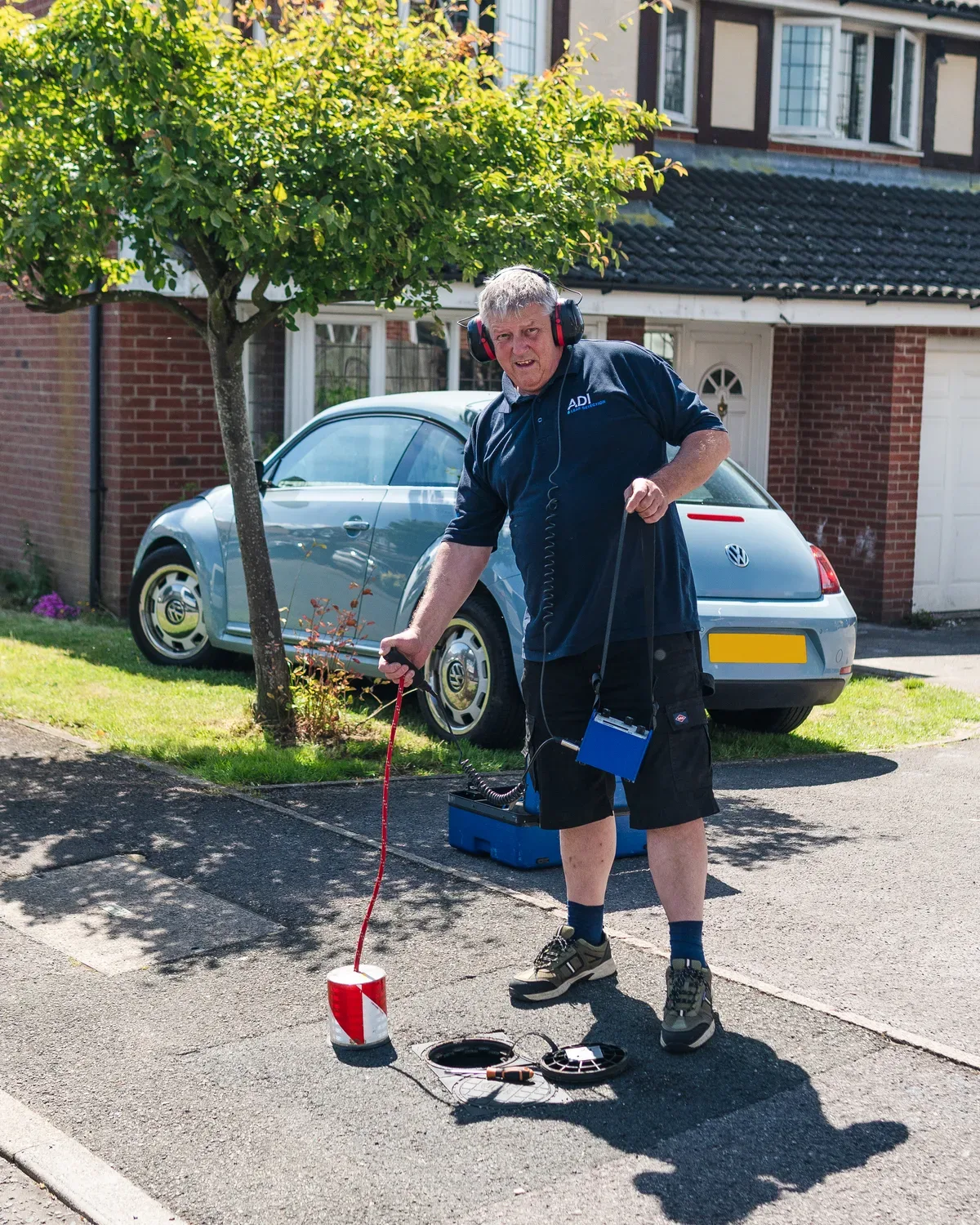 ADI specialist using an acoustic ground microphone at a residential property